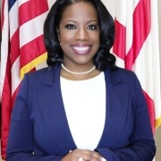 Smiling professional woman in front of flags