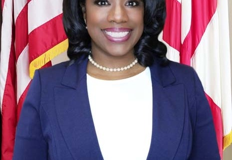 Smiling professional woman in front of flags